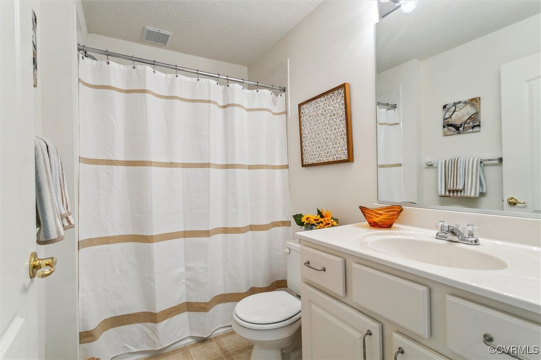 262 Claiborne Drive Williamsburg, VA 23185 - Photo 26 of 49 Bathroom with vanity, a textured ceiling, and a sh