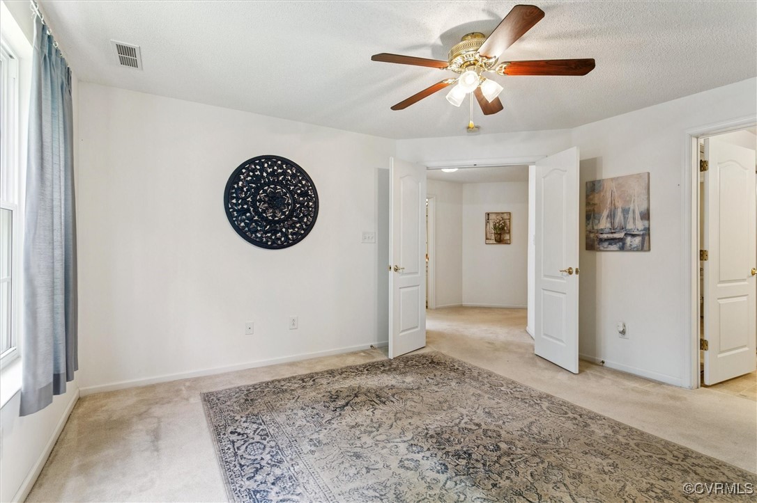 262 Claiborne Drive Williamsburg, VA 23185 - Photo 30 of 49 Empty room with light carpet and ceiling fan