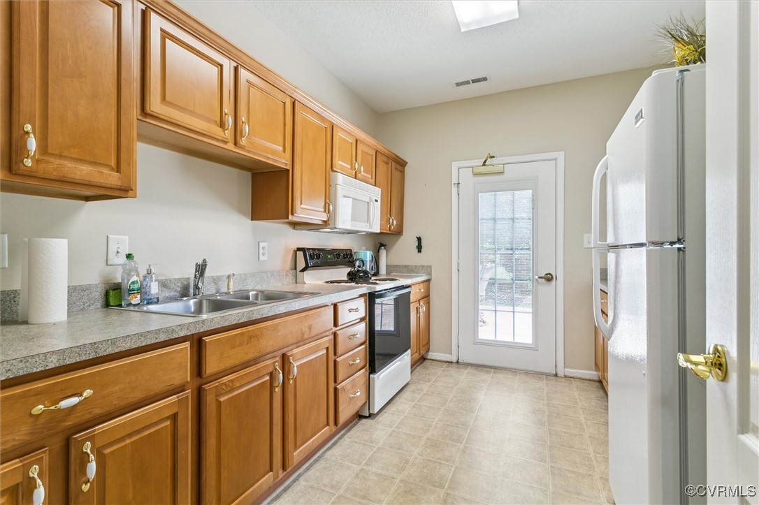 262 Claiborne Drive Williamsburg, VA 23185 - Photo 45 of 49 Kitchen featuring white appliances, brown cabinets