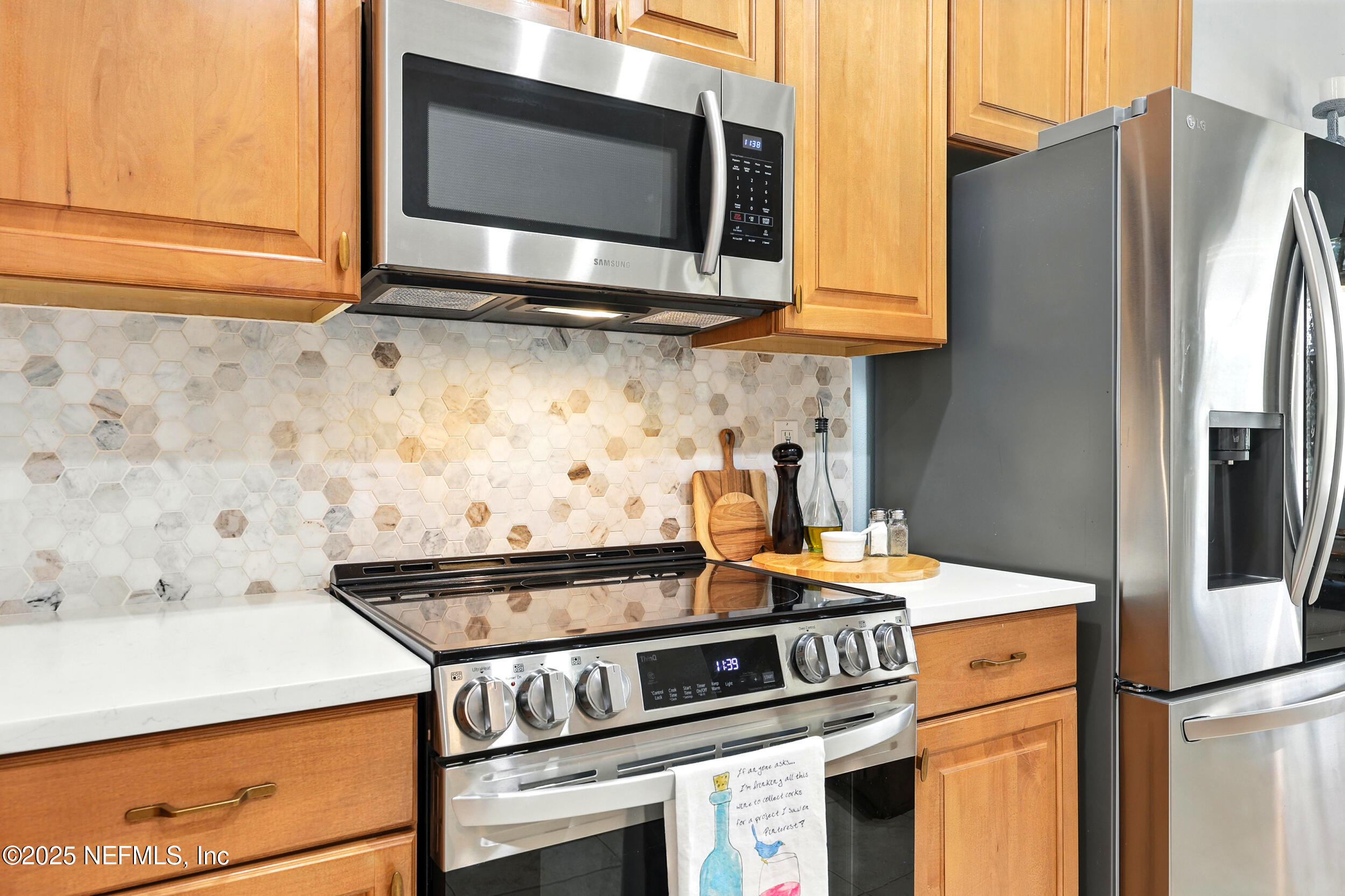 1185 Garrison Drive St. Augustine, FL 32092 - Photo 18 of 70 a kitchen with stainless steel appliances granite countertop a stove and a microwave
