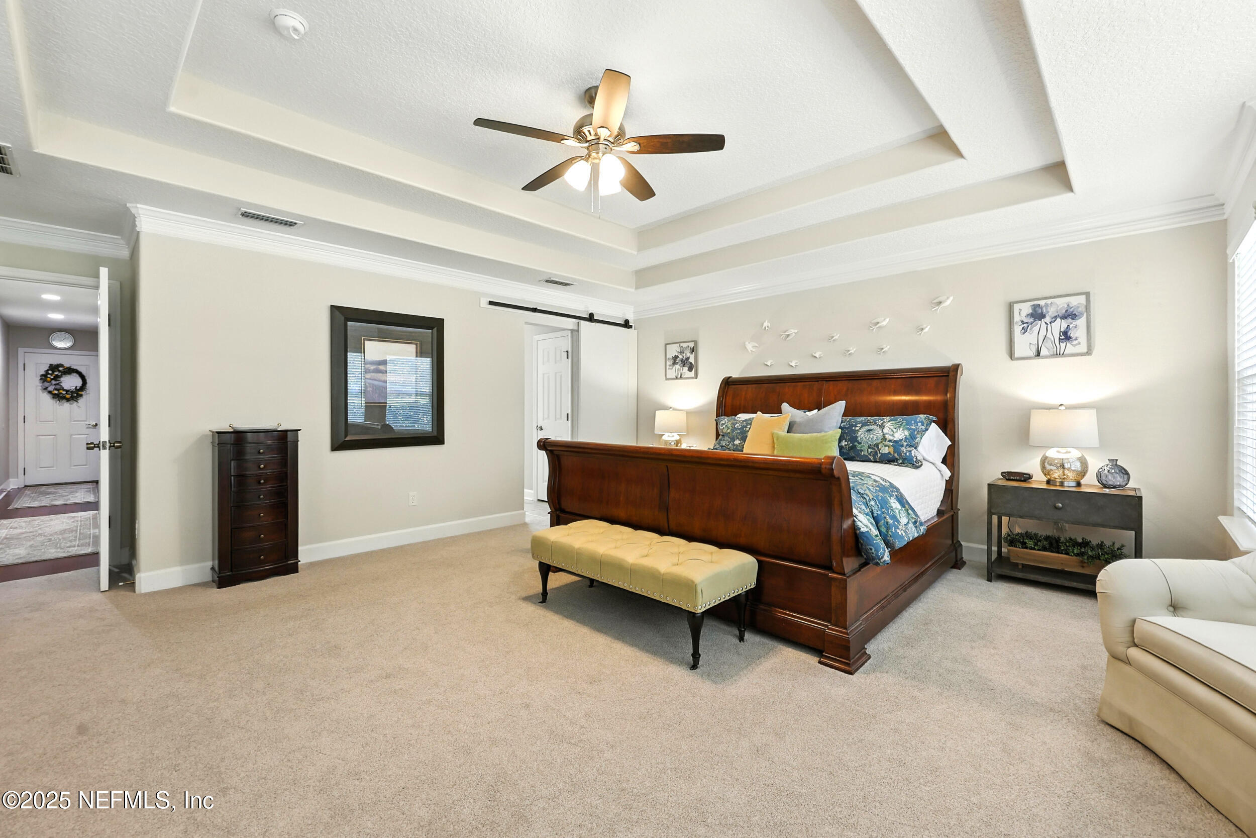 1185 Garrison Drive St. Augustine, FL 32092 - Photo 23 of 70 a bedroom with a bed and a chandelier