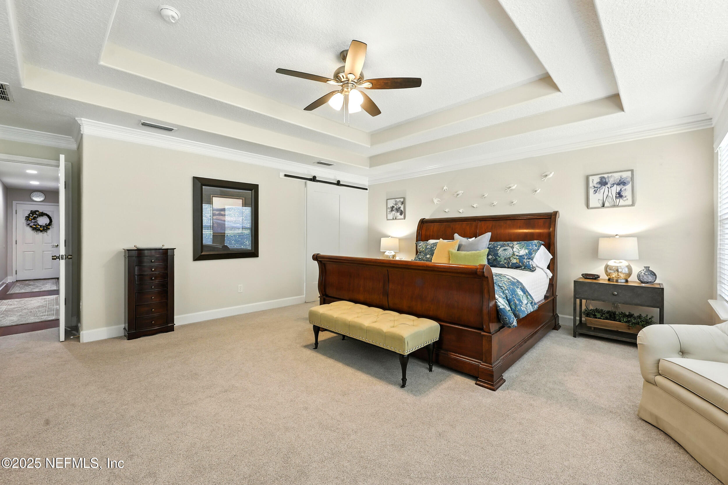 1185 Garrison Drive St. Augustine, FL 32092 - Photo 24 of 70 a bedroom with a bed and a chandelier