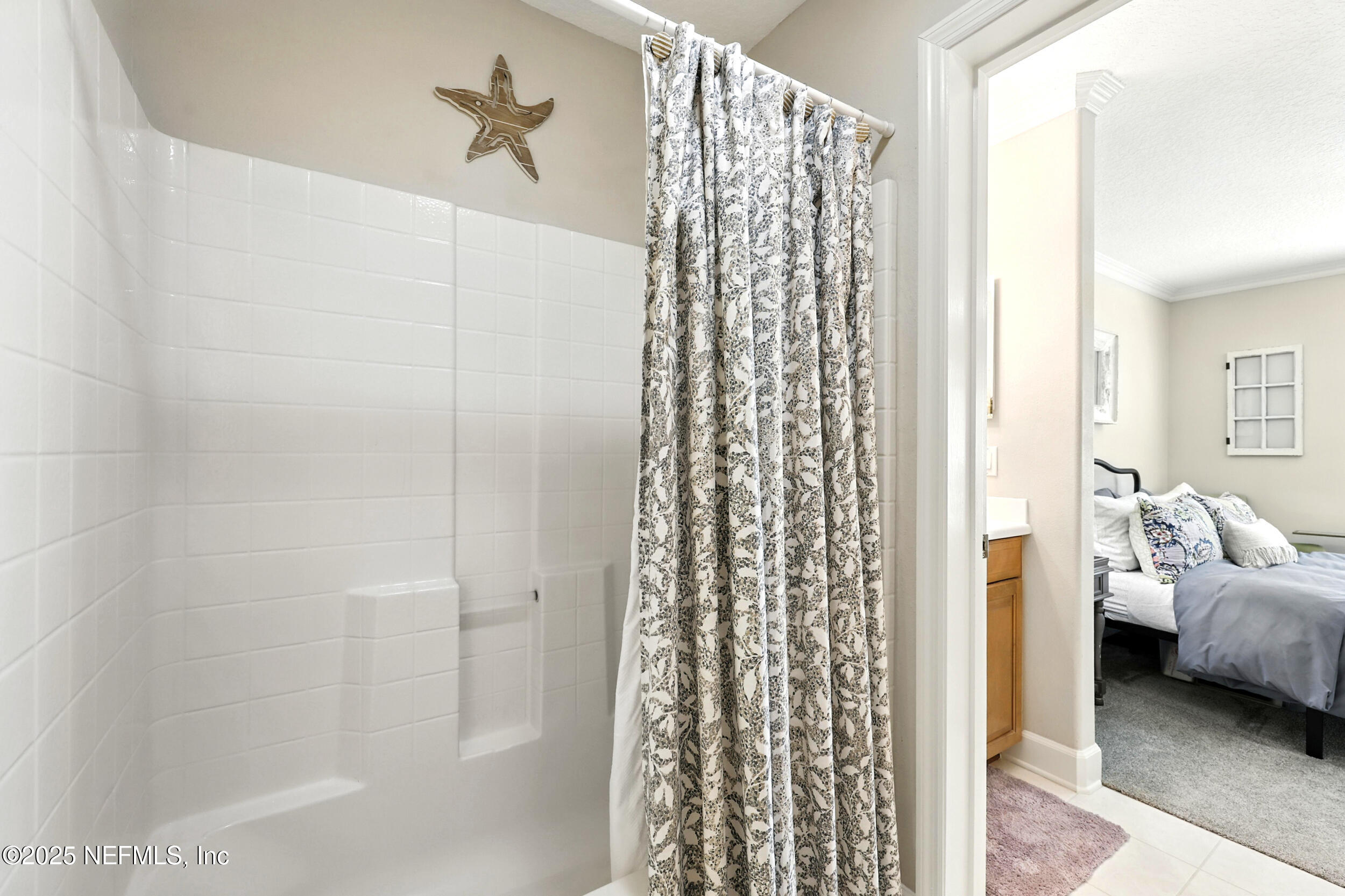 1185 Garrison Drive St. Augustine, FL 32092 - Photo 33 of 70 a en suite bathroom with a shower curtain and a window