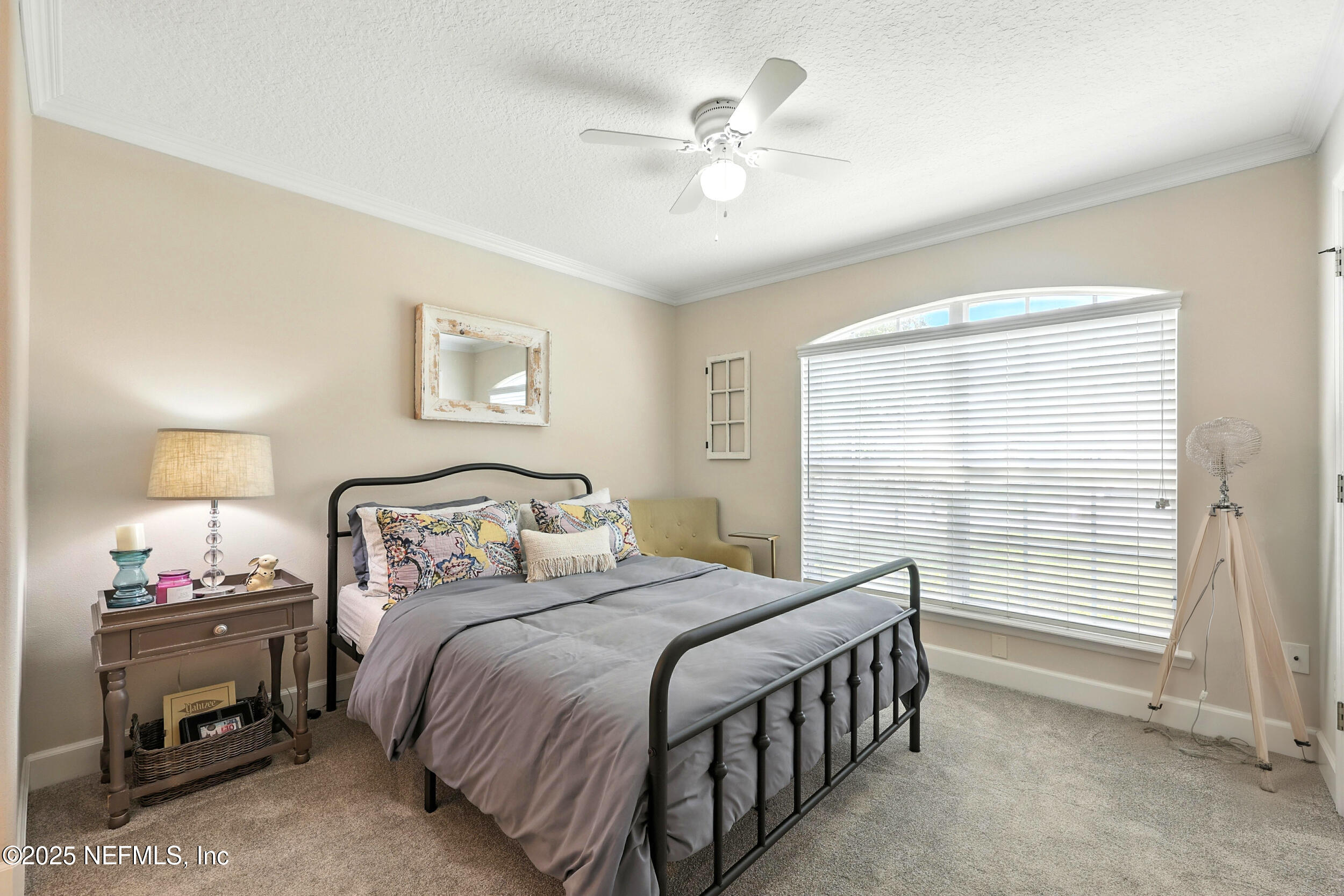 1185 Garrison Drive St. Augustine, FL 32092 - Photo 35 of 70 a bedroom with a bed and a chandelier