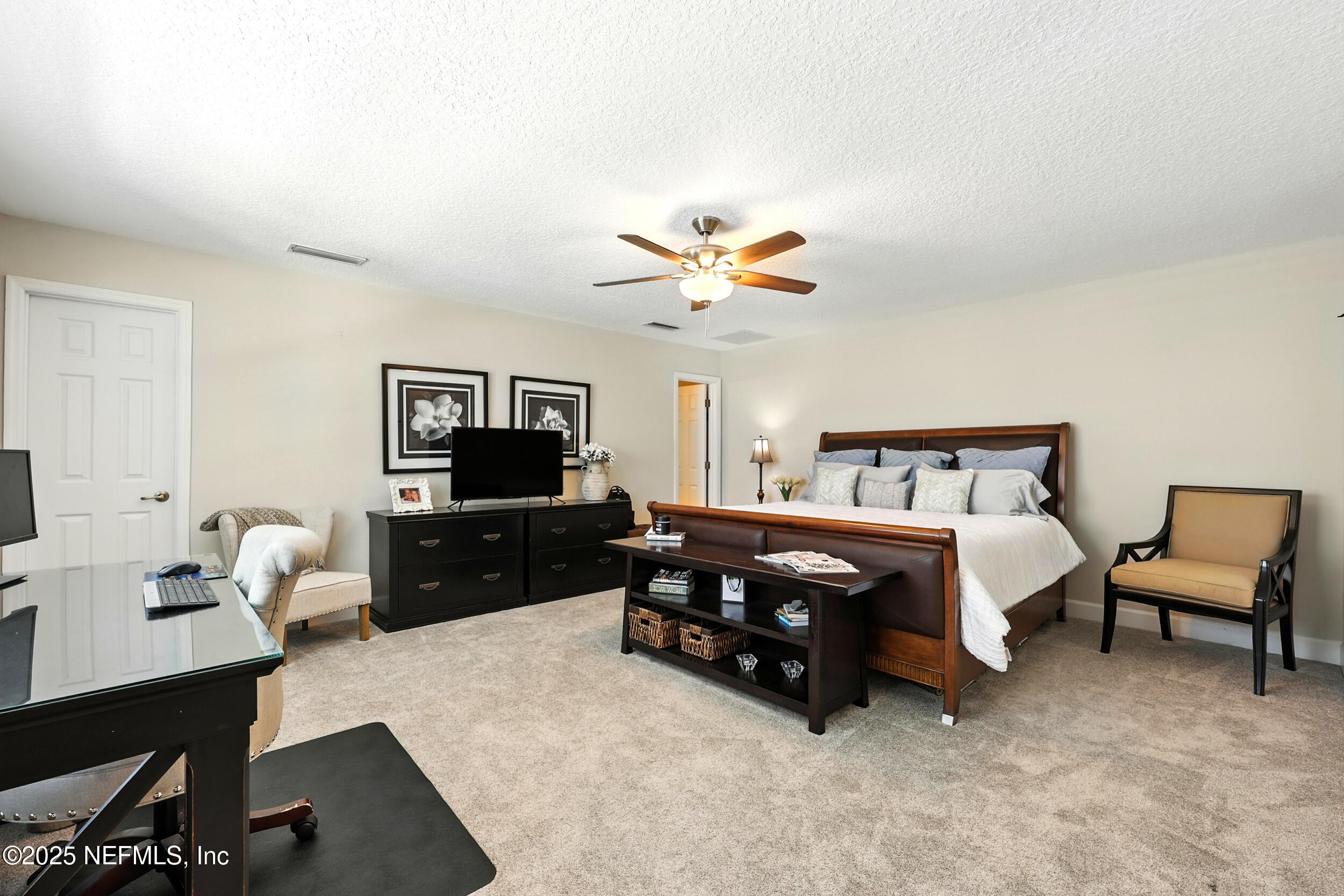 1185 Garrison Drive St. Augustine, FL 32092 - Photo 38 of 70 a bedroom with a bed and a flat screen tv