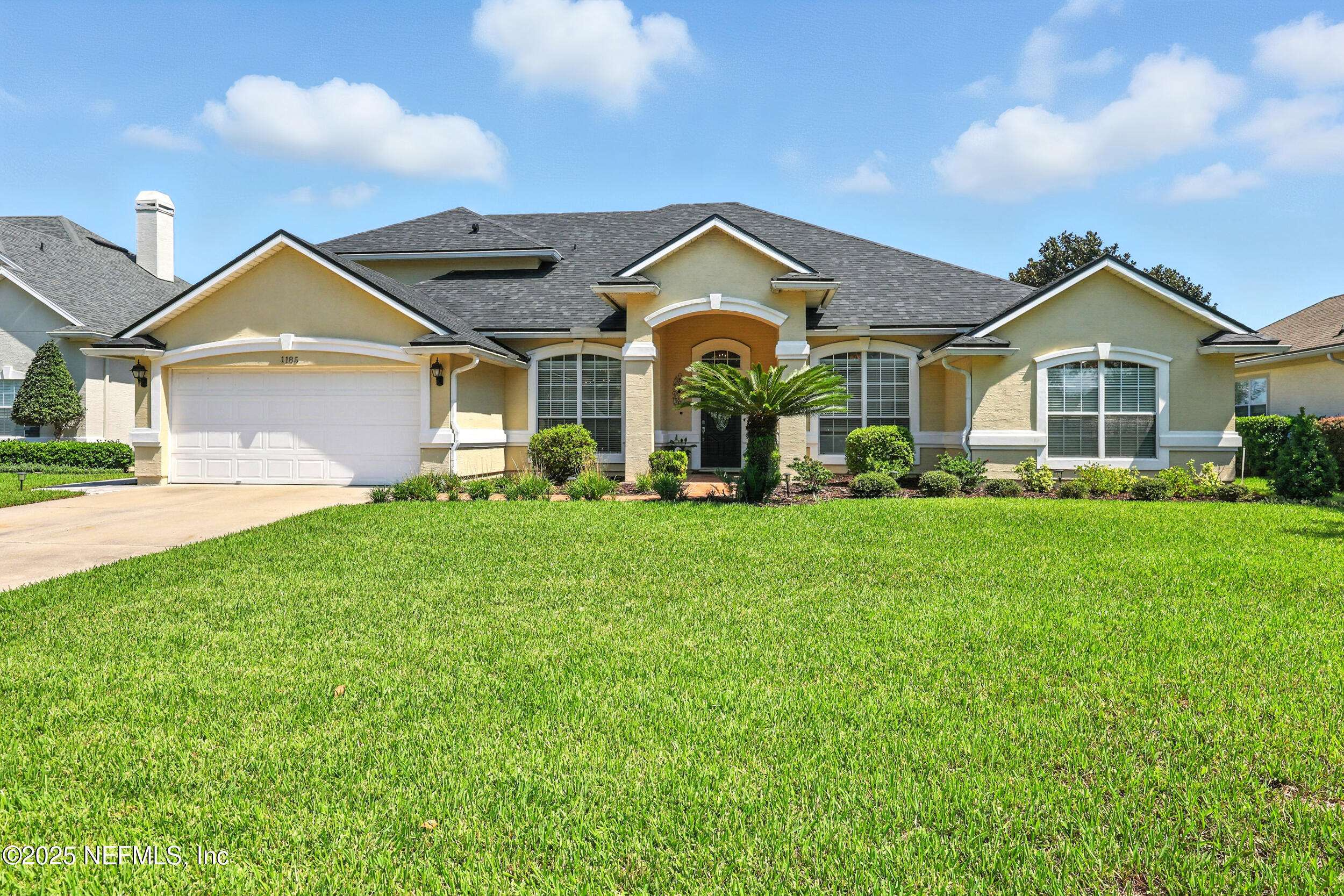 1185 Garrison Drive St. Augustine, FL 32092 - Photo 46 of 70 a front view of a house with a garden and trees