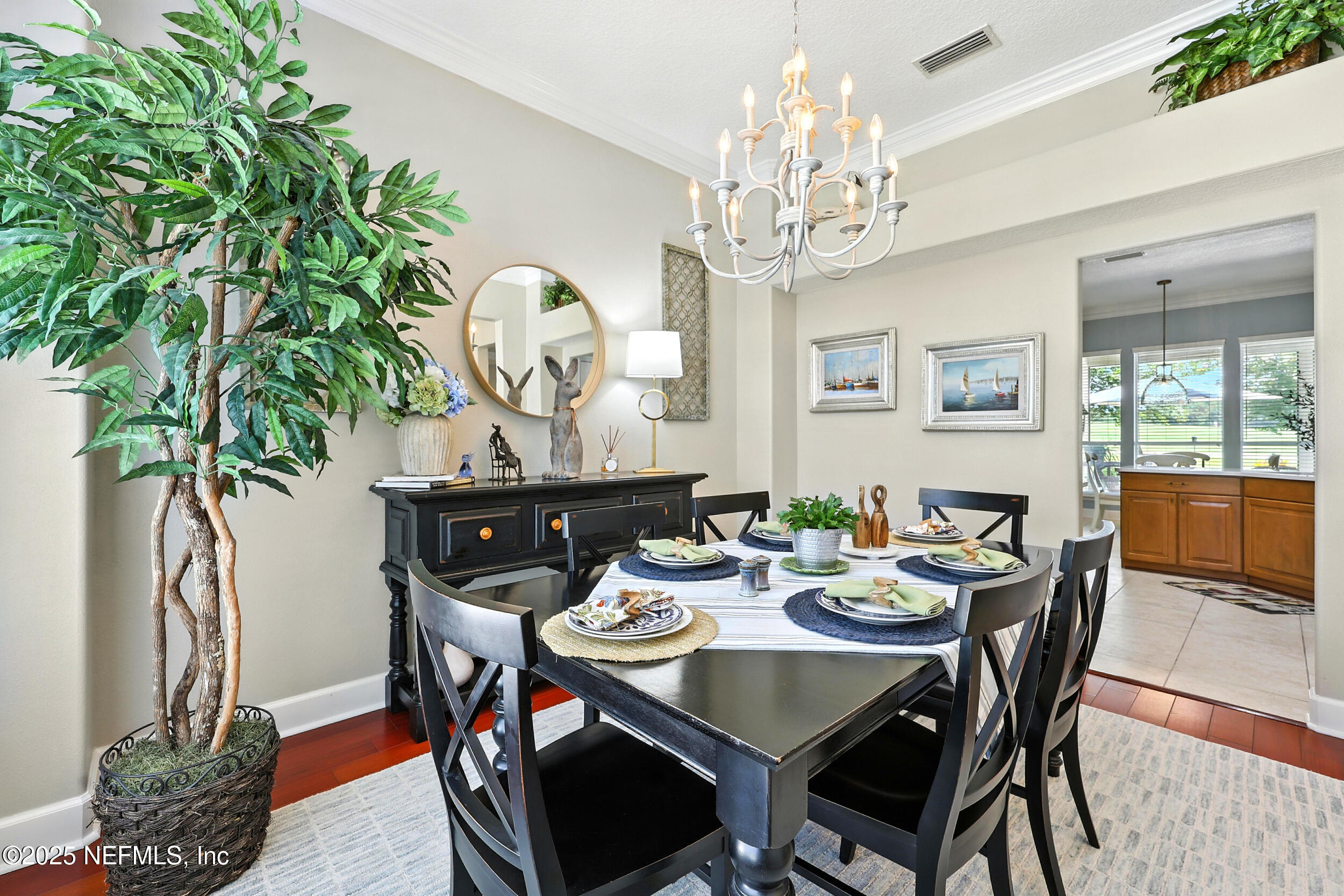 1185 Garrison Drive St. Augustine, FL 32092 - Photo 9 of 70 a view of a dining room with furniture a chandelier and wooden floor