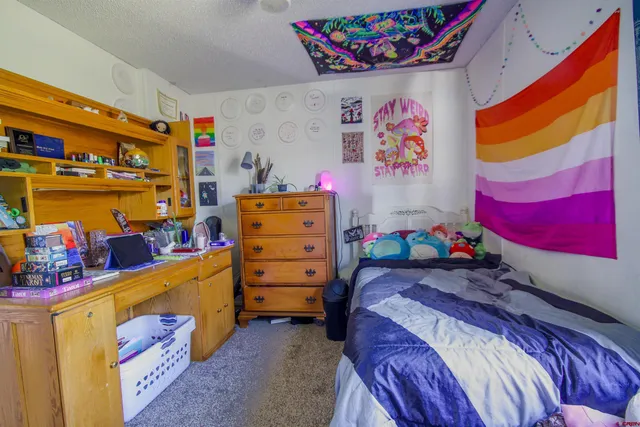 a view of a garage with furniture and a refrigerator