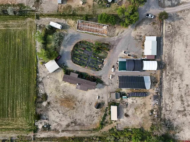a backyard of a house with lots of green space and a fountain