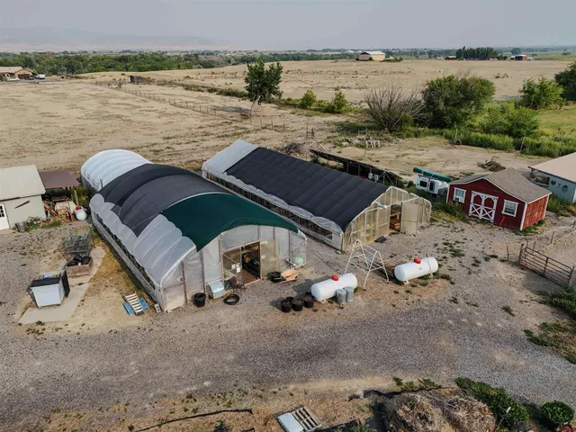 a backyard of a house with lots of green space and a fountain