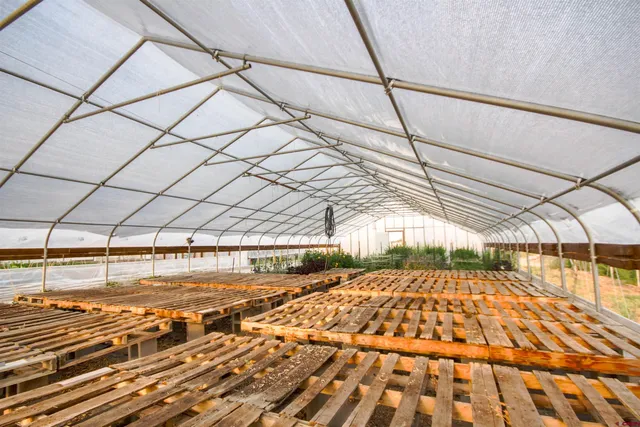 a kitchen with stainless steel appliances granite countertop a stove a sink dishwasher and cabinets with wooden floor