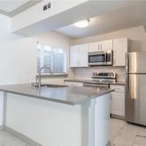 a kitchen with stainless steel appliances granite countertop a refrigerator stove a sink and a microwave