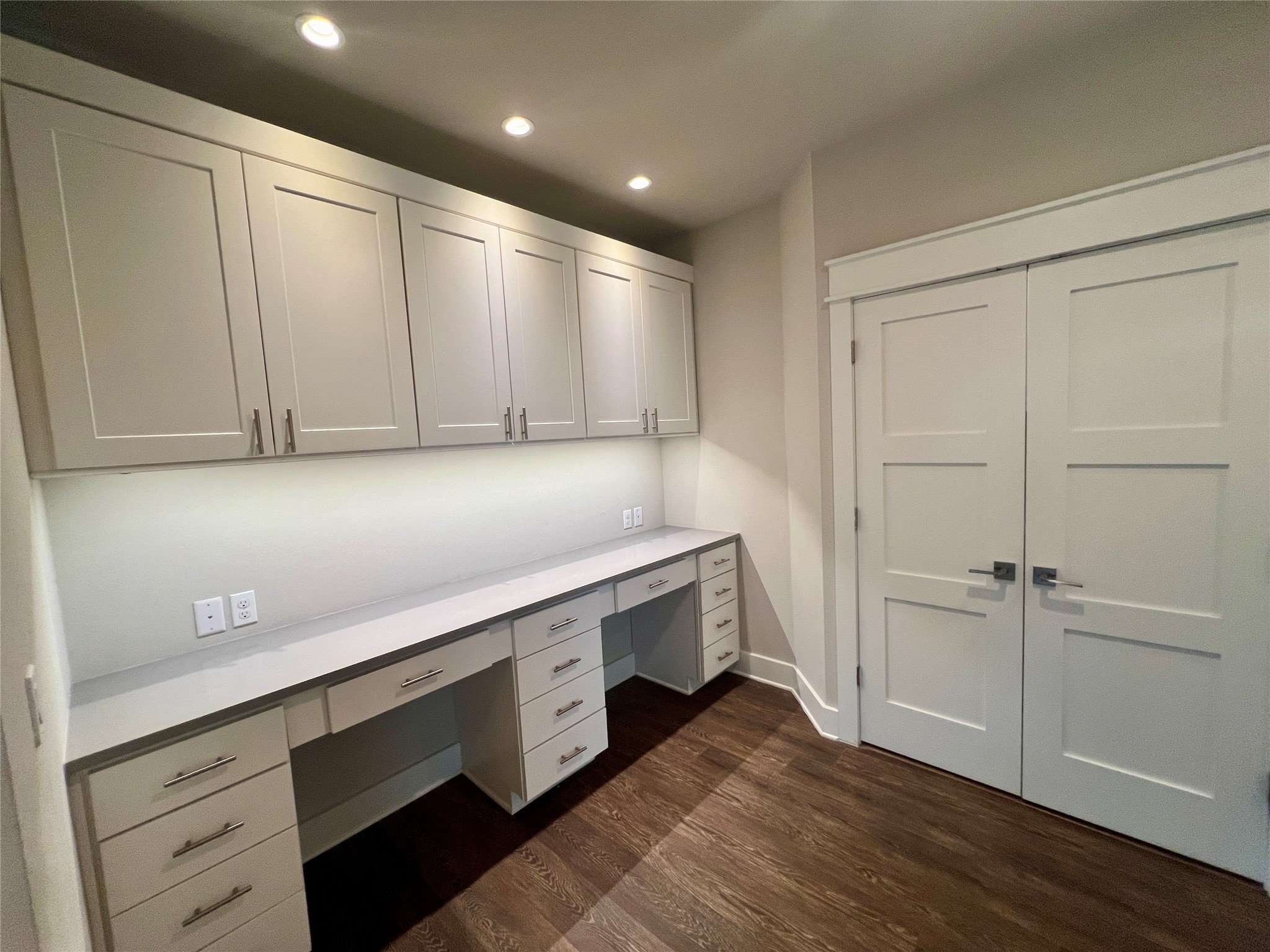 6515 Davis Lane, Unit 10 Austin, TX 78749 - Photo 17 of 22 Integrated built-in desk and cabinetry offer a streamlined workspace with rich hardwood flooring.