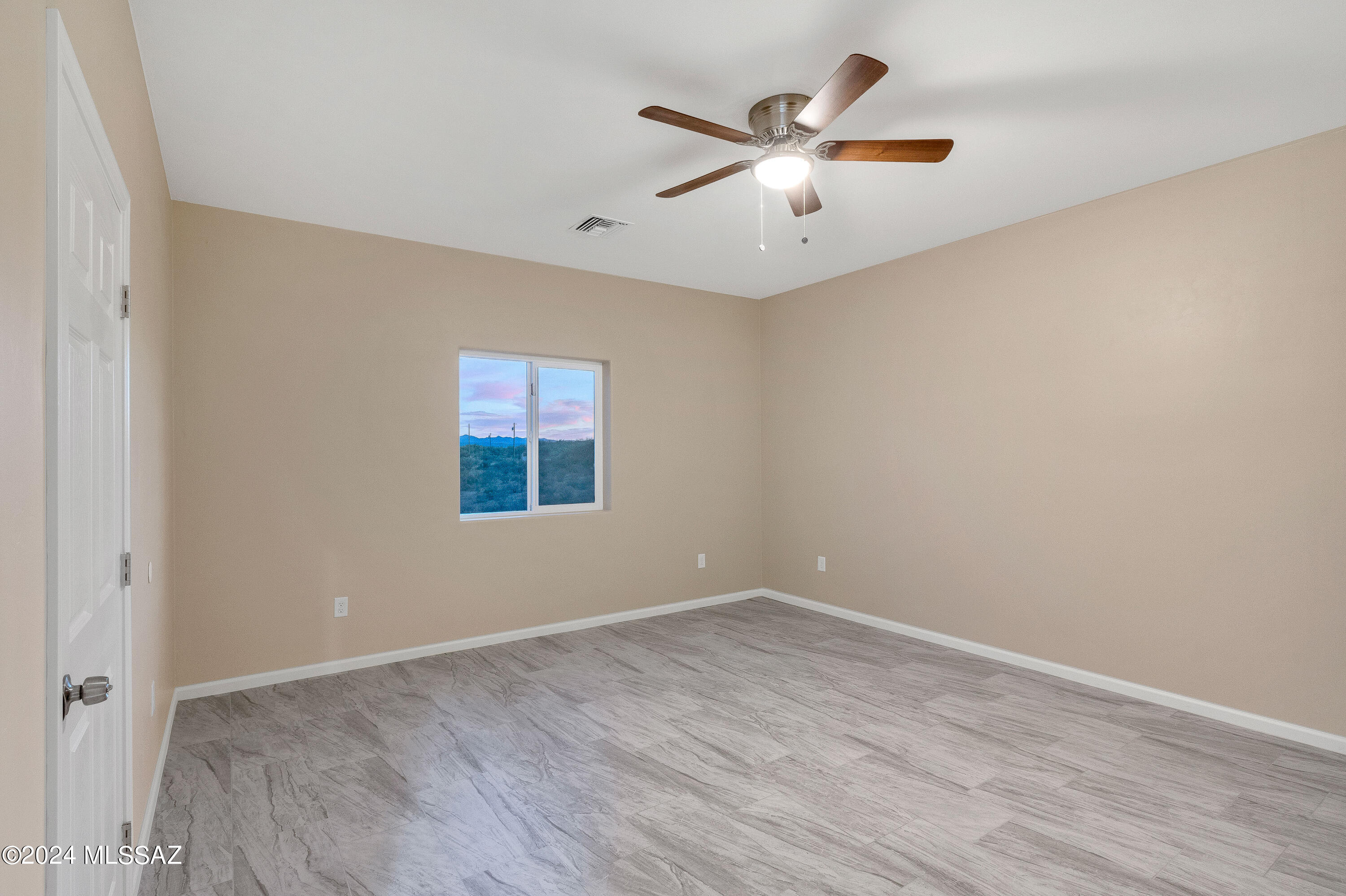 356 Globo Court Rio Rico, AZ 85648 - Photo 15 of 32 wooden floor in an empty room with a window