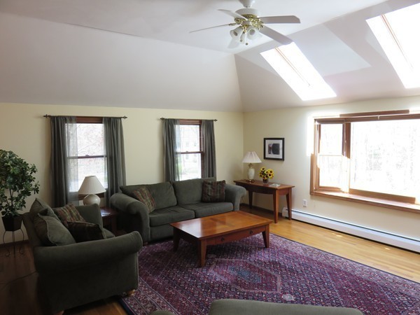 18 Nevada Road Tyngsborough, MA 01879 - Photo 11 of 22 a living room with furniture a rug and a large window