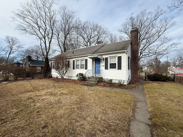 a view of a house with a yard covered in snow