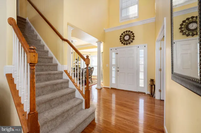 a dining room with furniture window and wooden floor
