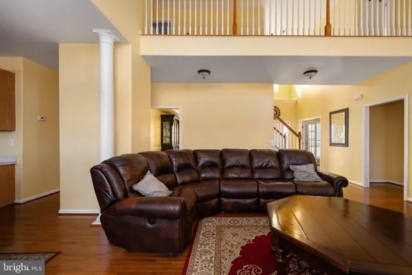 a large kitchen with kitchen island a large counter top space appliances and cabinets