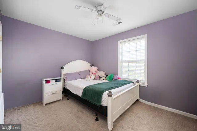 a living room with furniture a couch and a flat screen tv