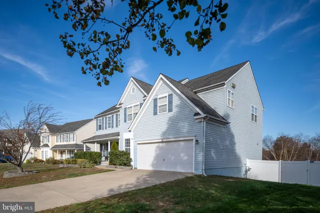 a front view of a house with a yard outdoor seating and plants