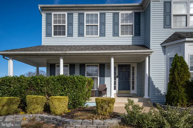 a view of a room with wooden floor and furniture