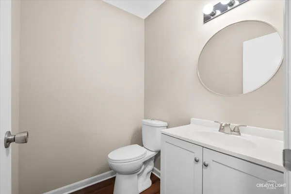 a bathroom with a sink mirror and toilet