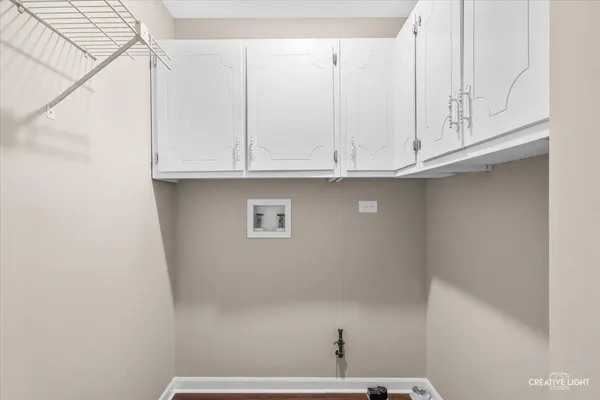 a view of kitchen with white cabinets and a wooden floor