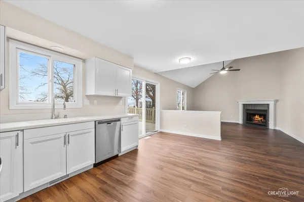 a view of a kitchen with a sink dishwasher and a microwave