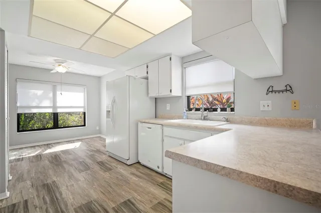 a view of a kitchen with a sink and cabinets