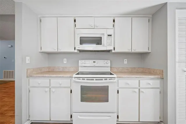 a stove top oven sitting inside of a kitchen