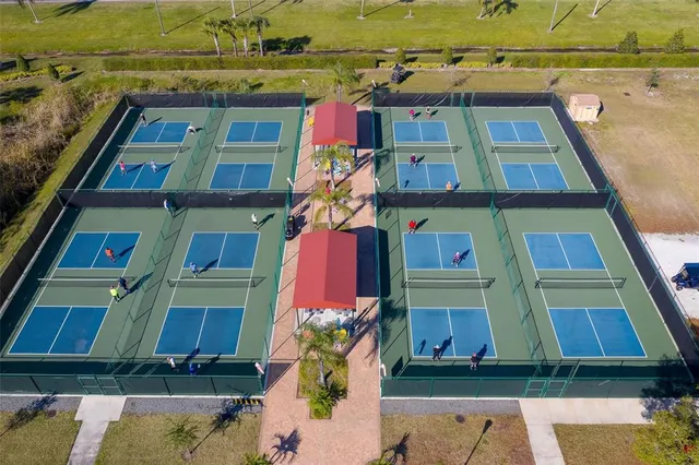 an aerial view of a swimming pool with seating area