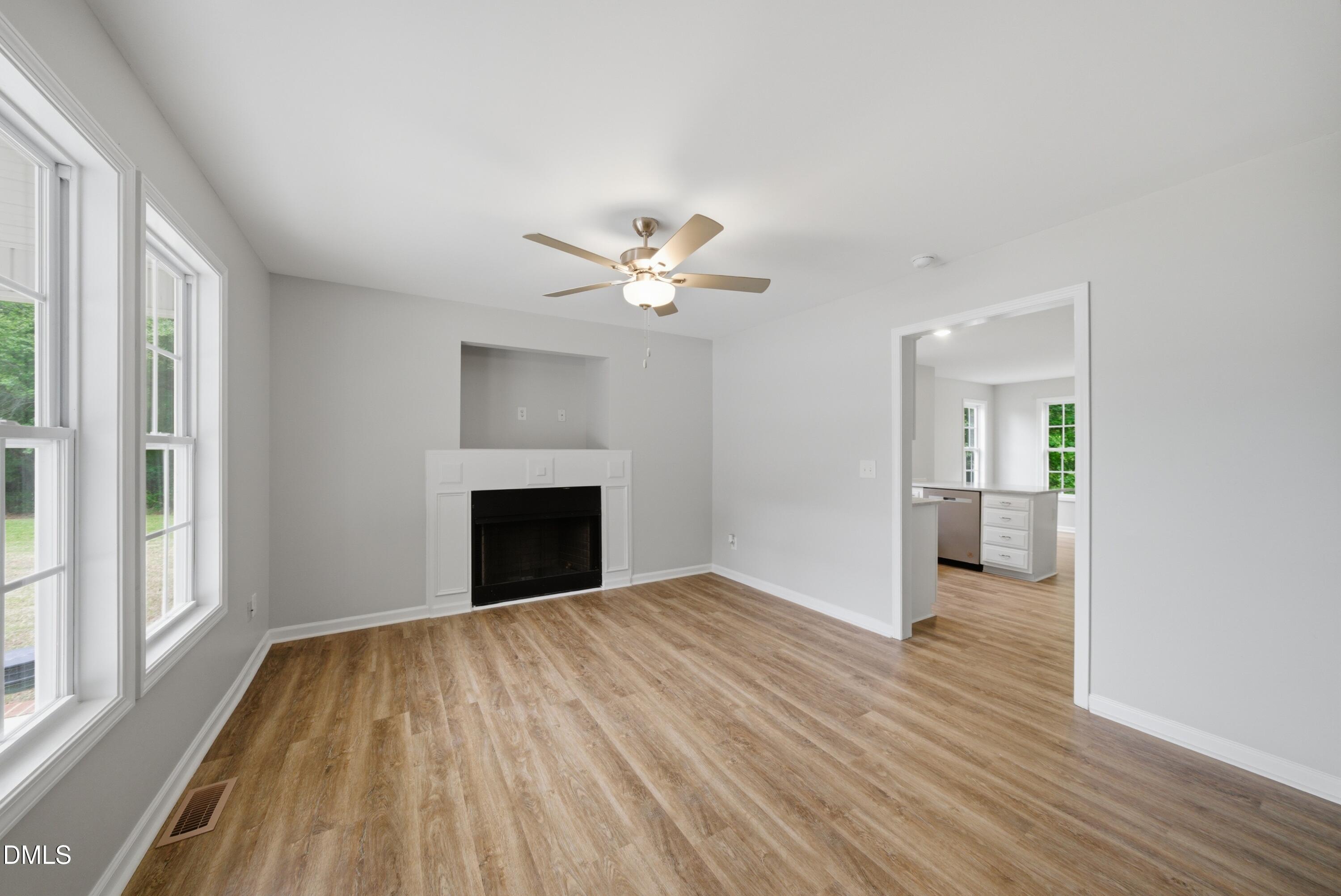 201 Tonylee Court, Unit A Raleigh, NC 27603 - Photo 6 of 30 wooden floor in an empty room with a fireplace