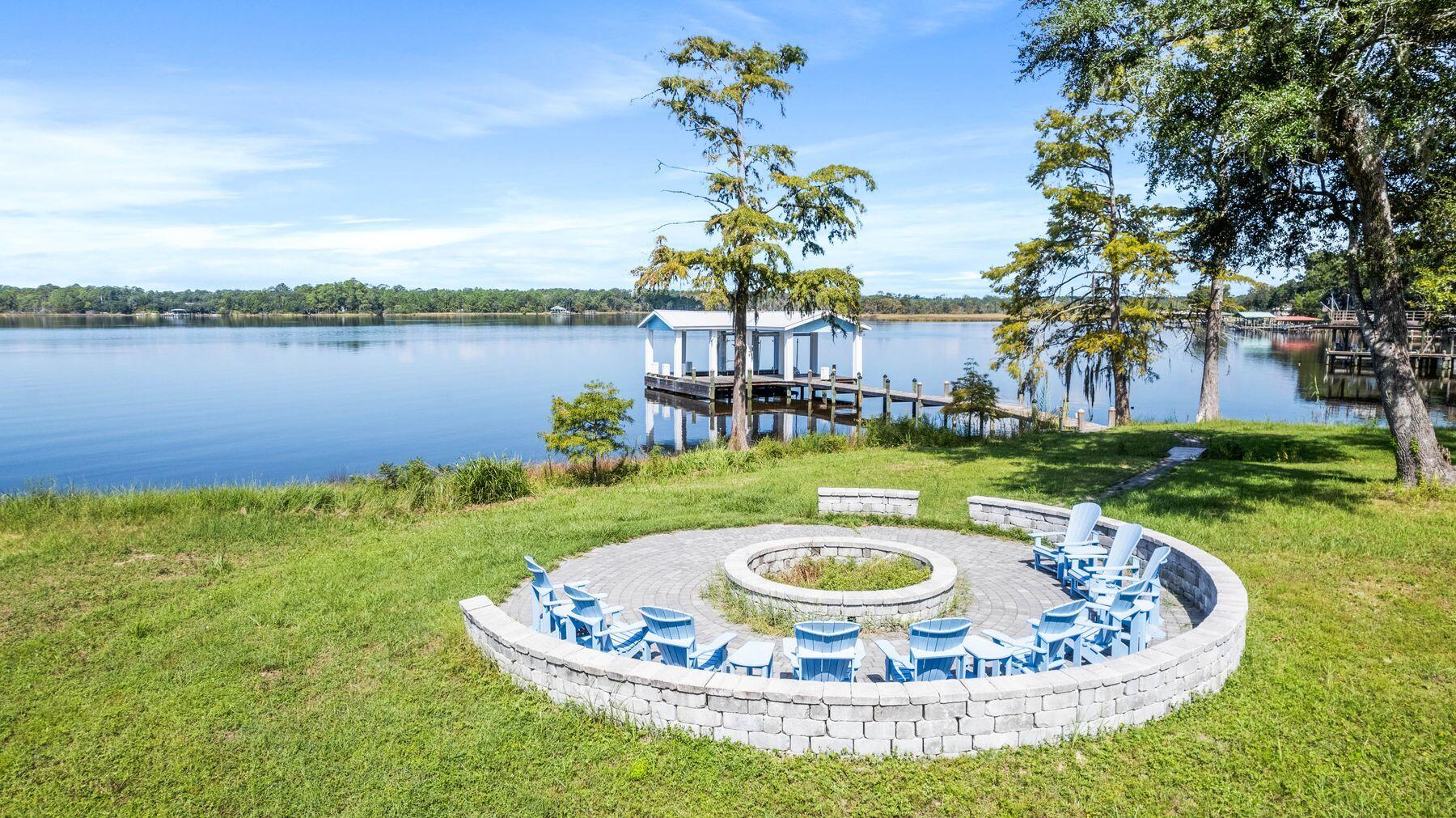 147 Dexton King Freeport, FL 32439 - Photo 7 of 23 a view of a swimming pool with lake and houses in the back