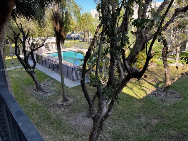 a view of a yard with a tree