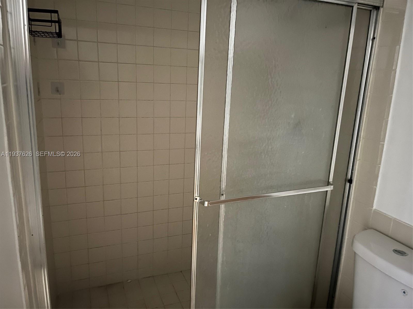 8420 Southwest 133rd Avenue Road, Unit 308 Miami, FL 33183 - Photo 16 of 16 a bathroom with a glass door shower