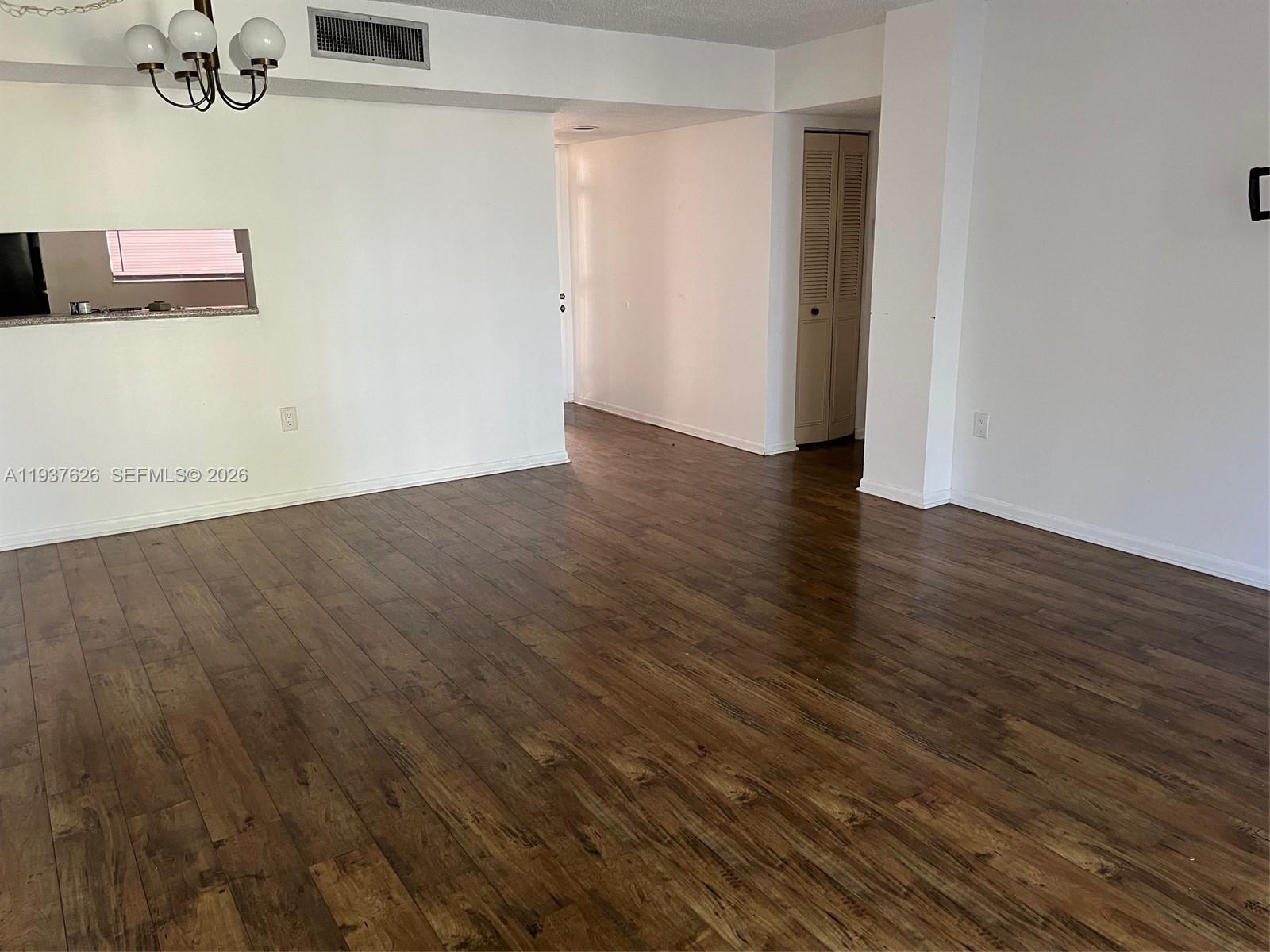 8420 Southwest 133rd Avenue Road, Unit 308 Miami, FL 33183 - Photo 4 of 16 an empty room with wooden floor and windows
