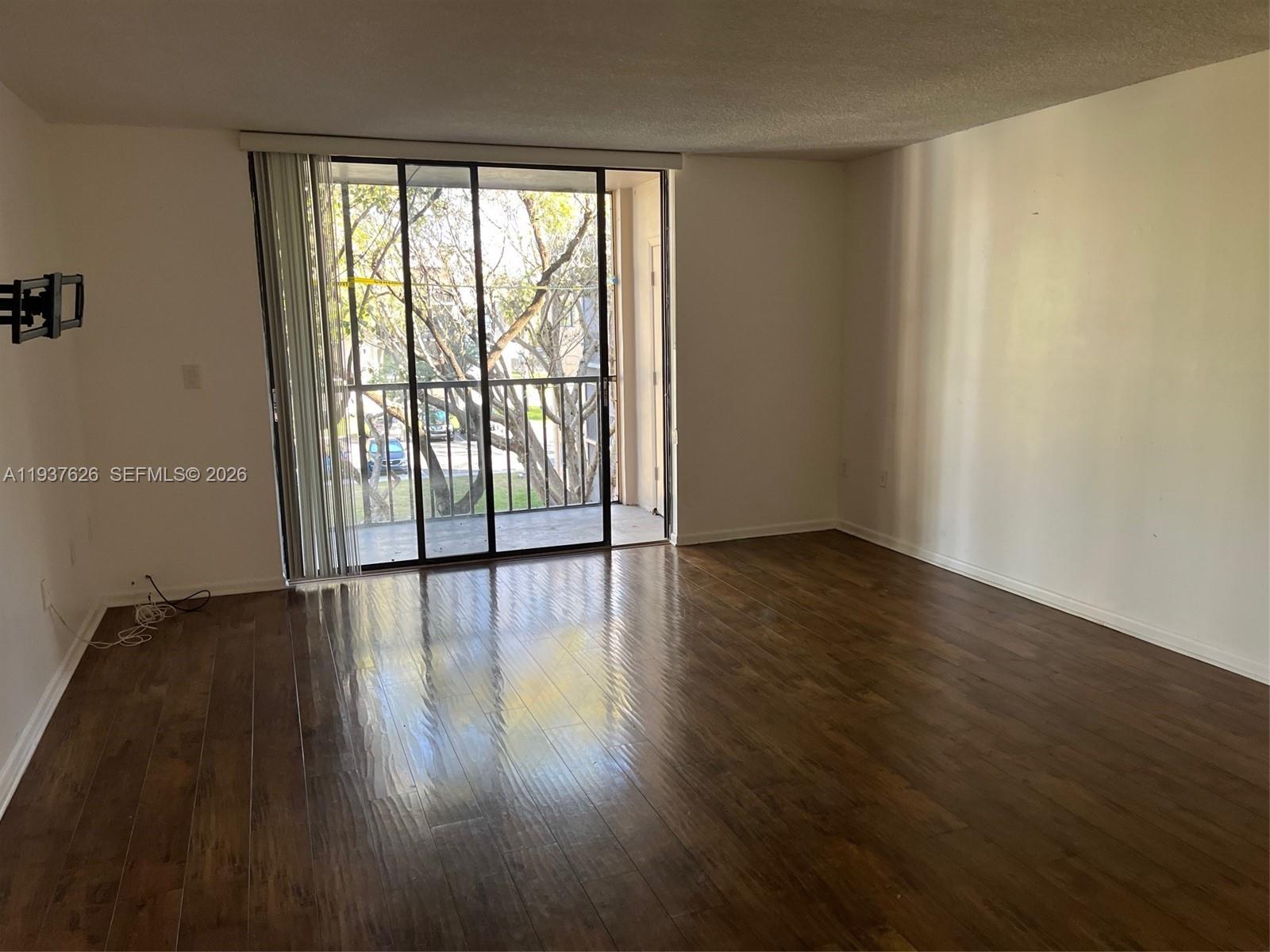 8420 Southwest 133rd Avenue Road, Unit 308 Miami, FL 33183 - Photo 5 of 16 wooden floor in an empty room with a window