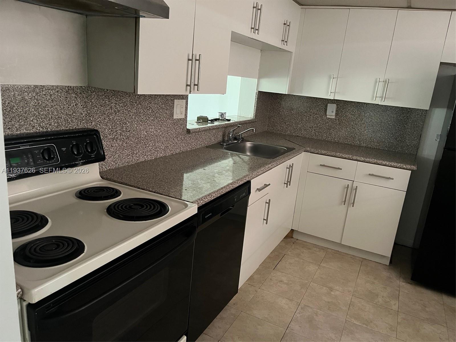 8420 Southwest 133rd Avenue Road, Unit 308 Miami, FL 33183 - Photo 6 of 16 a kitchen with a stove and a sink