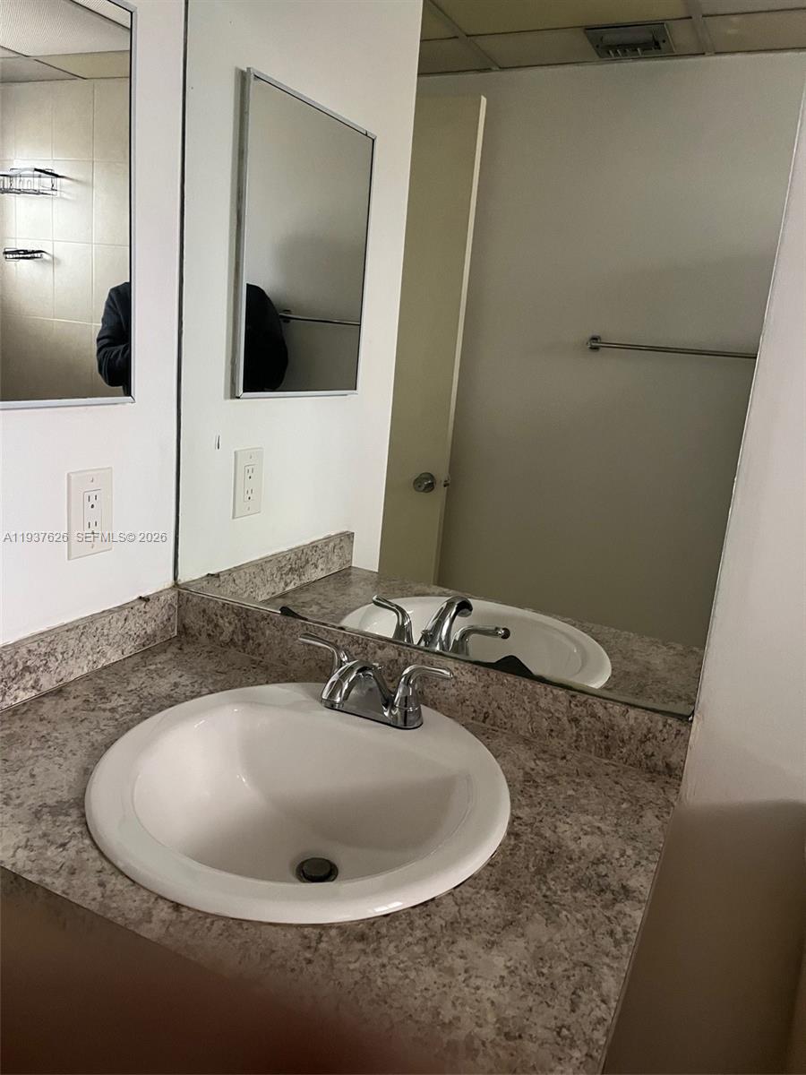 8420 Southwest 133rd Avenue Road, Unit 308 Miami, FL 33183 - Photo 10 of 16 a bathroom with a sink and a mirror