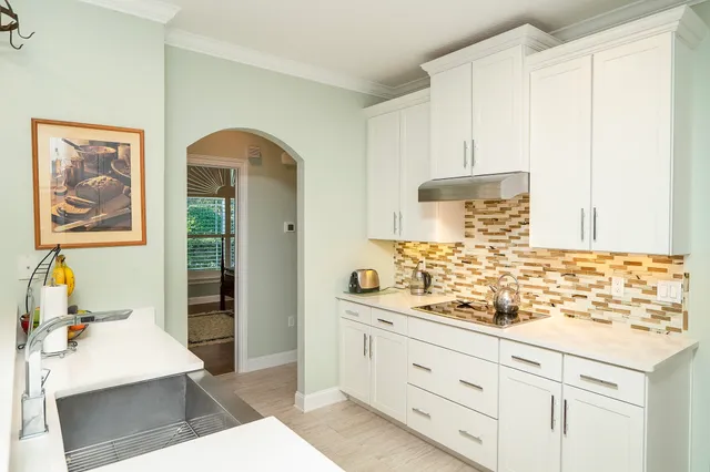 a front view of a house with a garden