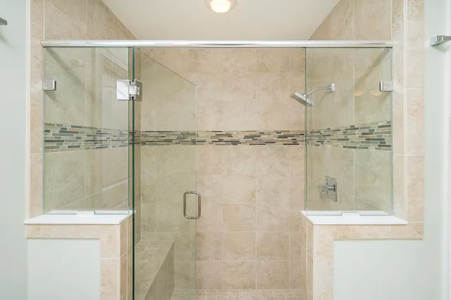 a living room with furniture kitchen view and a window