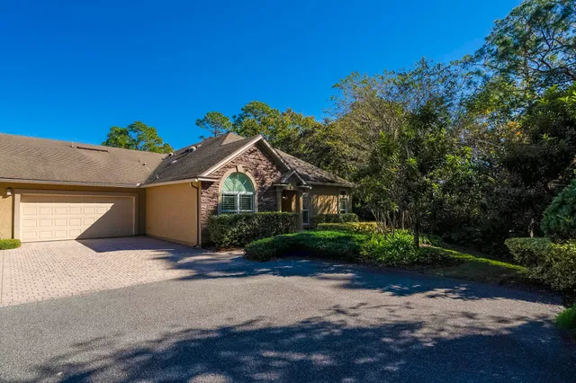 a view of a backyard with wooden fence and a bench