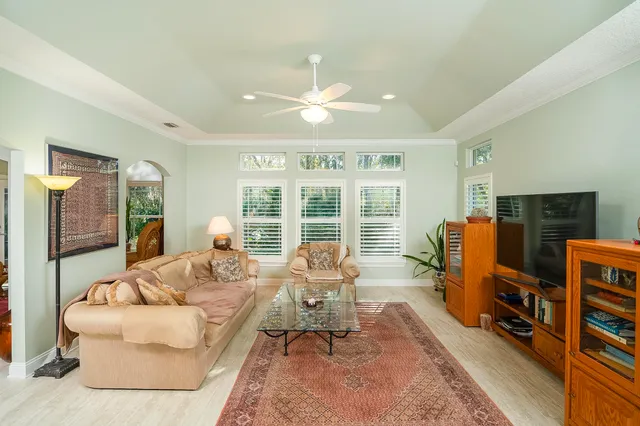 a living room with furniture and a chandelier