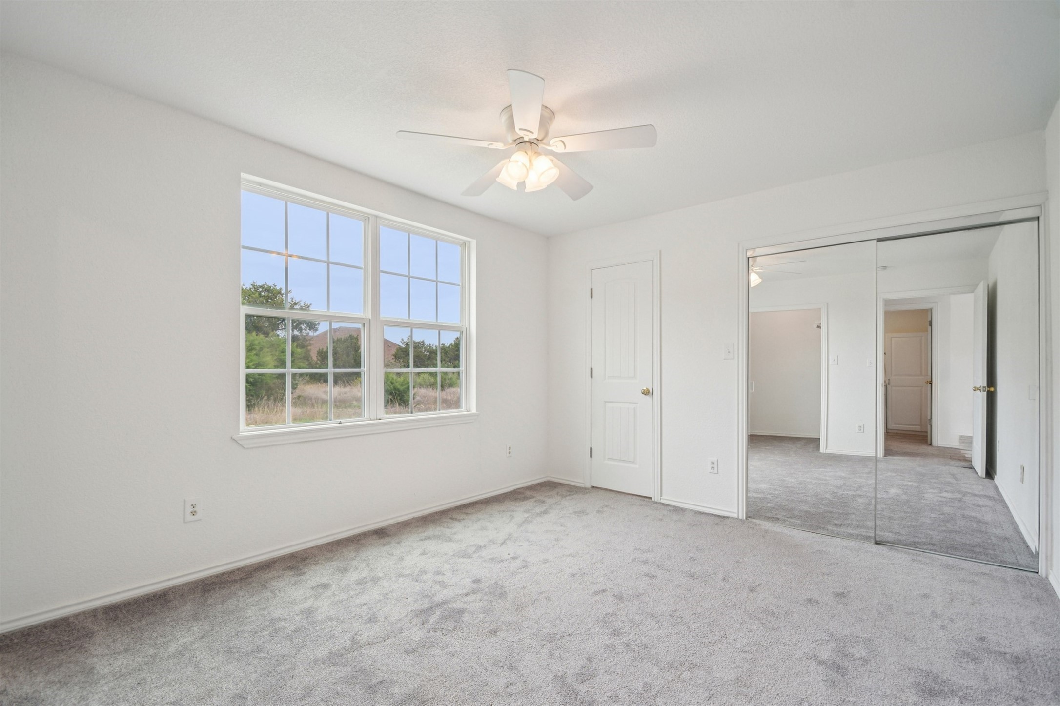 1470 Oak Grove Road Leander, TX 78641 - Photo 12 of 38 an empty room with a ceiling fan and a window