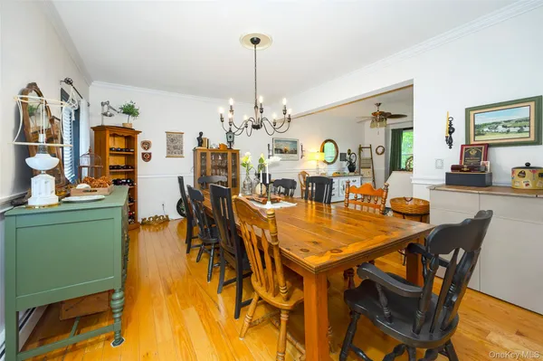 a view of a dining room with furniture and chandelier