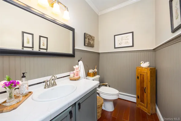 a bathroom with a sink vanity mirror and toilet