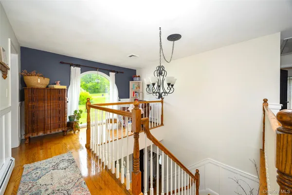 a view of a livingroom with furniture an entryway and wooden floor