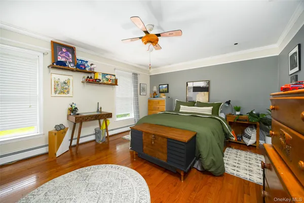 a bedroom with furniture and a wooden floor