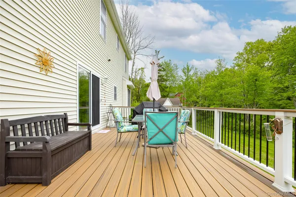 a view of balcony with wooden floor and outdoor seating