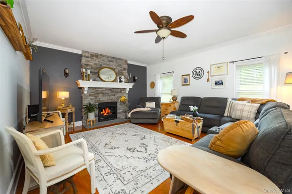 a living room with furniture a fireplace and a large window